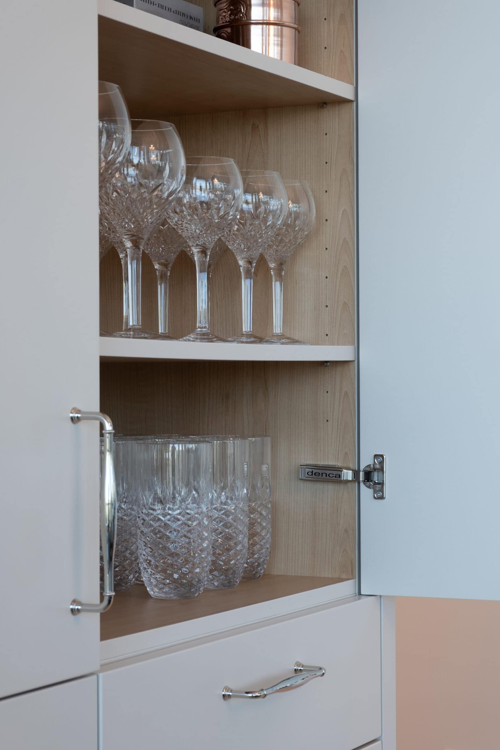 Stylish home with white cabinetry and oak wood finishes.