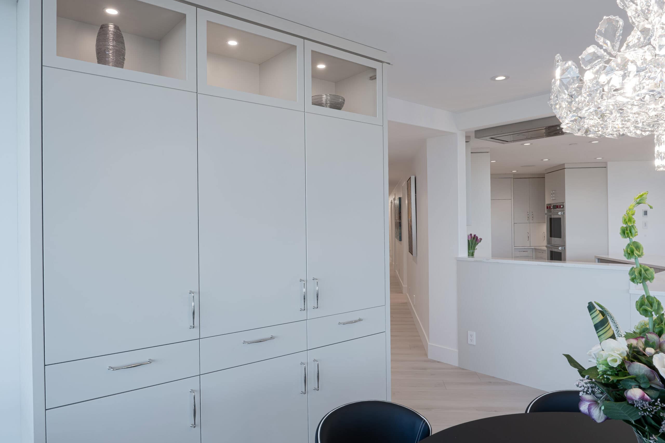 Stylish home with white cabinetry and oak wood finishes.