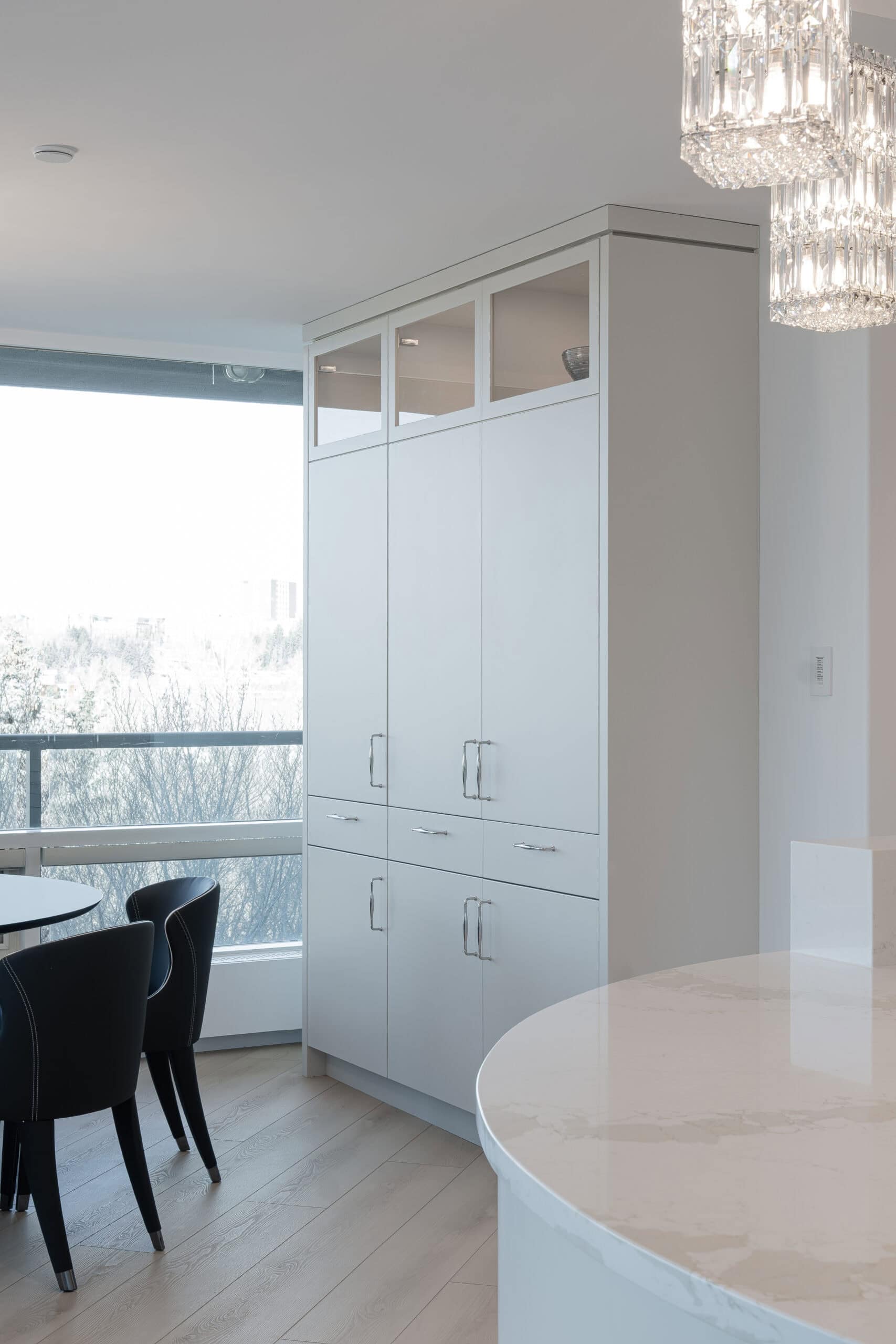 Stylish home with white cabinetry and oak wood finishes.