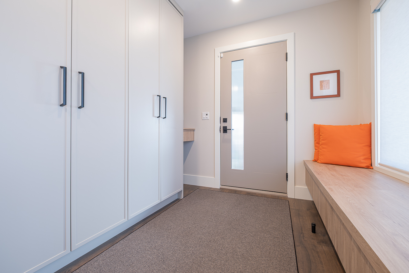 Stylish home with white cabinetry and oak wood finishes.