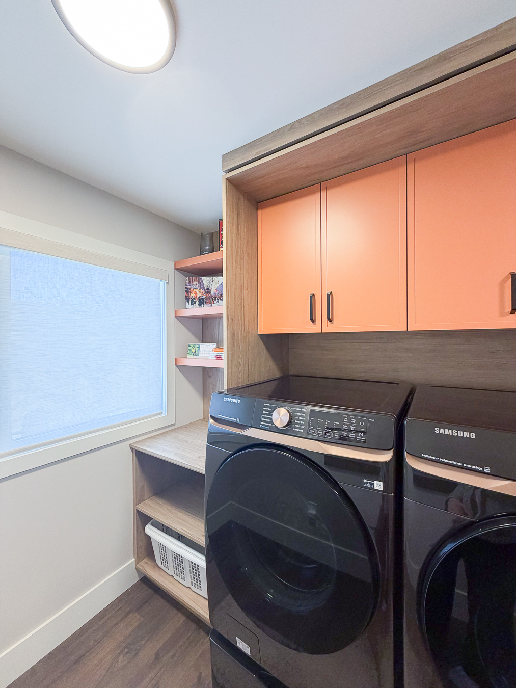 Stylish home with white cabinetry and oak wood finishes.