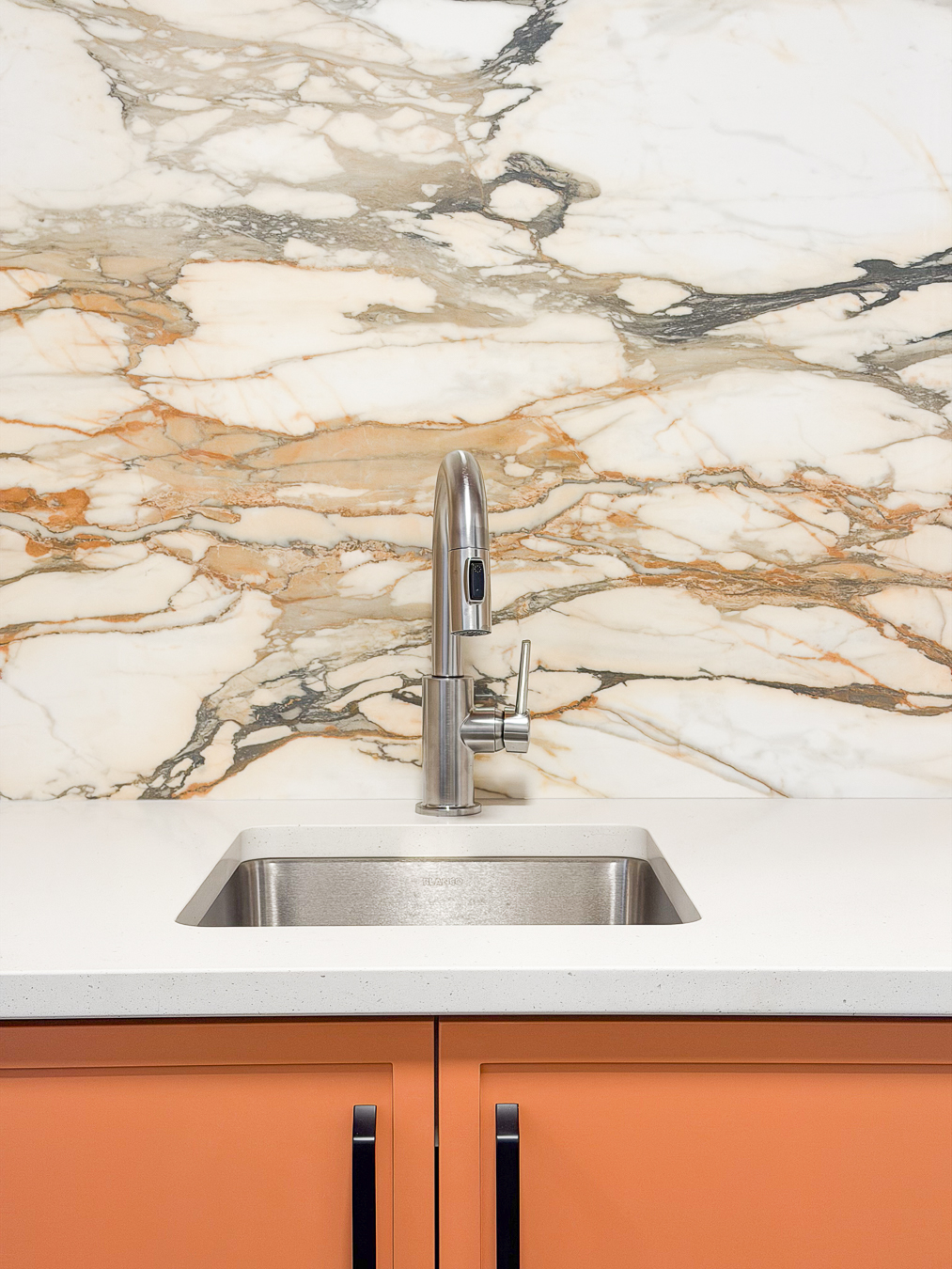 Stylish home with white cabinetry and oak wood finishes.
